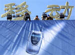Chinese workers install a giant Motorola poster. Photo: Reuters/Andrew Wong