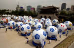 32 giant soccer balls representing each country playing in the World Cup. Photo: Reuters/Petar Kujundzic