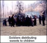Soldiers distrubuting sweets to children