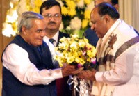 Vajpayee presents a bouquet to Pawar