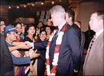 President Clinton breaks the security cordon to shake hands with the Maurya Sheraton staff
