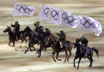 Horsemen carry Olympic flags during the opening ceremony 