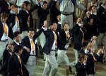Members of a combined delegation of North and South Korea raise their arms together 