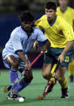 Dhanraj Pillay wins the ball from Australia's Mathew Wells. REUTERS/Jose Miguel Gomez 