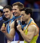 Alexi Nimov (centre), China's Yang Wei (R) and Ukraine's Alexander Beresch 