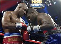 Evander Holyfield (L) and Hasim Rahman collide during their fight.