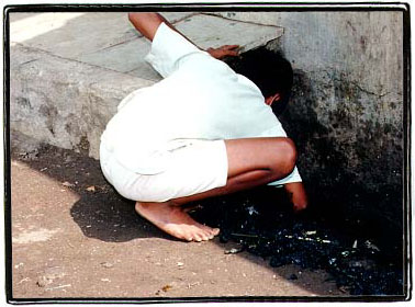 Cleaning the sewer with his bare hands